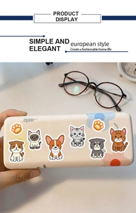Detailed view of a beige eyeglass case featuring cute cartoon cat and dog paw patterns