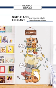 Close-up of stacked cartoon cats wall sticker with colorful fish and welcome sign decor
