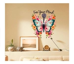 Wall decal of woman with floral butterfly wings and Free Your Mind text in cozy bedroom decor