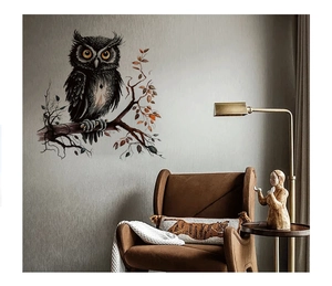 Realistic black owl wall sticker perched on a branch in a modern living room setting