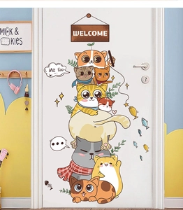 Detailed view of cartoon stack cats wall decal with welcome sign on a white door