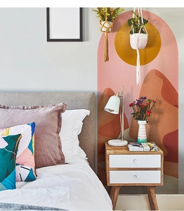 Detail of bohemian arch wall decal with abstract sun and desert mountain landscape in a bedroom