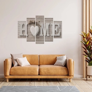 Modern 5-piece HOME canvas wall art set with grey wood grain background over leather sofa