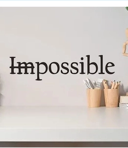 Close-up of inspirational POSSIBLE wall sticker in a minimalist home office setting