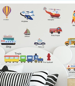 Detail view of colorful cartoon vehicle wall stickers on a white wall in a kid bedroom