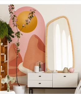Detail view of modern irregular wood frame mirror against abstract sun wall art