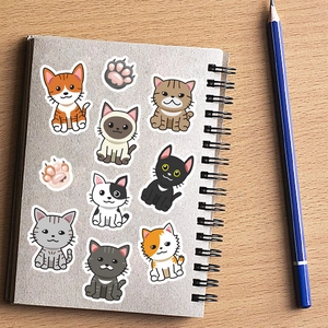 Cartoon cat stickers set with paw prints on a spiral notebook for room decoration