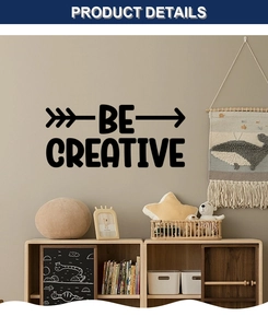 Detail showing BE CREATIVE wall sticker with arrows in a minimalist bedroom decor setting