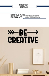 Detailed view of BE CREATIVE black vinyl wall decal in a minimalist Nordic room setting