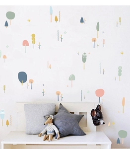 Detailed view of forest wall stickers in Morandi tones on a white nursery wall