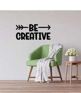 Close-up of BE CREATIVE black vinyl wall decal with arrow design in a modern living room