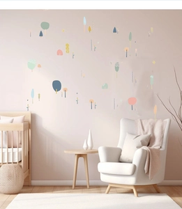 Detailed view of colorful cartoon forest wall stickers in a cozy nursery room setting