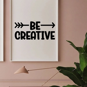 Minimalist 'BE CREATIVE' wall sticker with arrows in a stylish modern living room