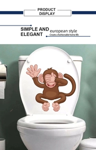 Funny cartoon monkey toilet lid decal showing see-no-evil pose on white background
