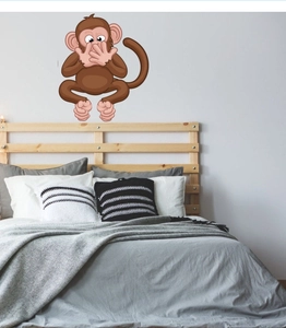 Funny cartoon monkey wall sticker showing a Speak No Evil pose in a cozy bedroom setting