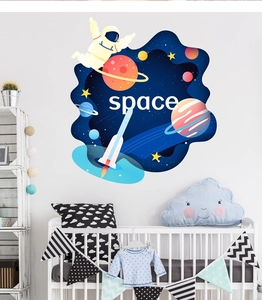 Nursery room wall detail with astronaut on whale and rocket space exploration decals