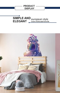 Detail of dreamlike astronaut wall decal featuring purple flowers on a bedroom wall