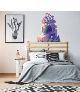 Close-up of a cartoon astronaut flower wall decal in a cozy minimalist bedroom setting