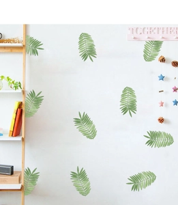 Detailed view of realistic green palm leaf wall decals on a clean white surface