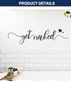Detail showing black Get Naked vinyl wall sticker with hearts on a white bathroom wall