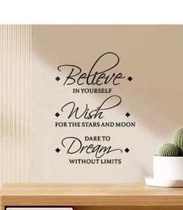 Detail of Believe motivational wall decal with black script lettering in a cozy home setting
