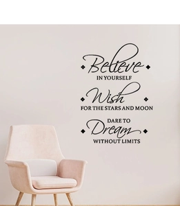 Detail of Believe Dream Wish wall stickers above a pink chair in a minimalist room