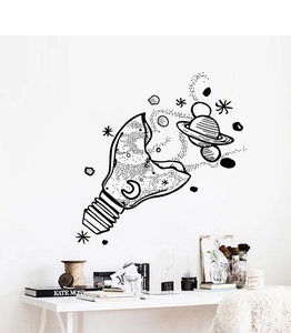 Detail view of artistic light bulb wall sticker with cosmic universe elements on a white wall