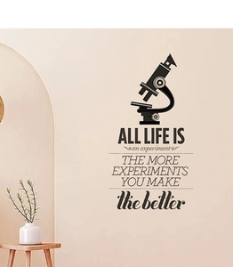 Detail view of vintage inspirational wall sticker with microscope and quotes in interior decor