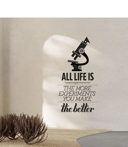 Detail of inspirational vintage quote wall sticker with microscope icon on white wall