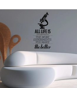 Detail of inspirational life experiment wall decal above a modern white sofa
