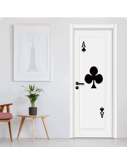Detailed view of the black Ace of Clubs poker decal on a modern white interior door