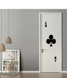 Detail of black Ace of Clubs door sticker on a white door in a modern living room