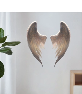 Detailed view of angel wing wall decals with fine feather textures on a white wall