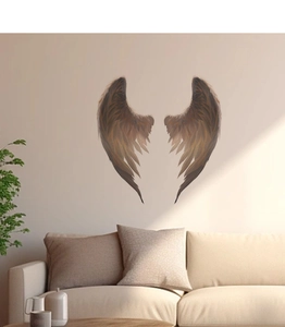 Detailed view of bronze angel wing wall stickers with textured feathers on a neutral wall