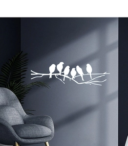 Detail of white birds on tree branches wall decals against a dark blue background