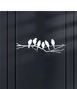 Detailed view of white birds on branches wall sticker on a dark grey textured wall background