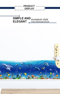 Detail of nautical wall sticker with dolphins, tropical fish and coral reef on white wall