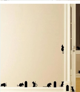 Détail des stickers muraux silhouettes de souris noires sur une plinthe blanche de salon