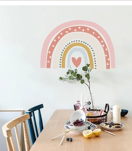 Detail of bohemian rainbow wall sticker with hearts on a clean white interior wall