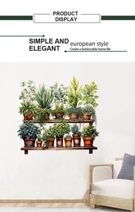 Detail of green potted plant wall stickers on wooden shelves above a cozy white sofa