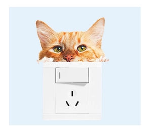 Close-up of a 3D orange tabby cat wall sticker peeping over a white light switch panel