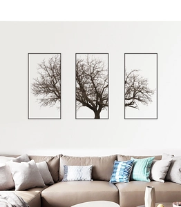 Detail of Nordic grey tree triptych wall art above a sofa in a modern minimalist living room
