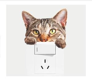 Realistic brown tabby cat wall sticker peering over a white light switch socket