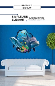 Detail of 3D ocean wall decal with dolphins and tropical fish above a modern sofa
