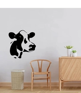 Black silhouette cow wall sticker decal applied to white wall in modern living room