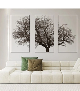 Detail of grey tree silhouette three-piece wall art set with slim black frames in a living room