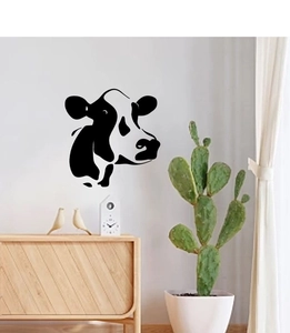 Minimalist black cow head wall sticker on white wall in a modern Nordic living room setting