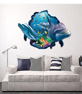 Detail of 3D ocean wall sticker showing blue dolphins and coral reef on a white wall