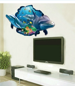 3D ocean scene wall decal with dolphins and tropical fish breaking through the living room wall