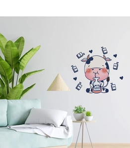 Detail showing cartoon cow wall decals with milk boxes on a living room wall